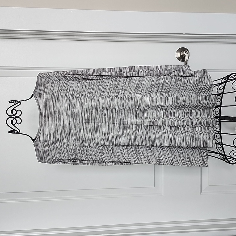 Gray, longsleeved top with brown button detail.